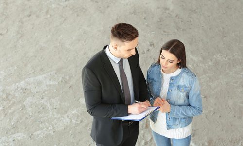 Insurance adjuster questions a woman making a home insurance claim